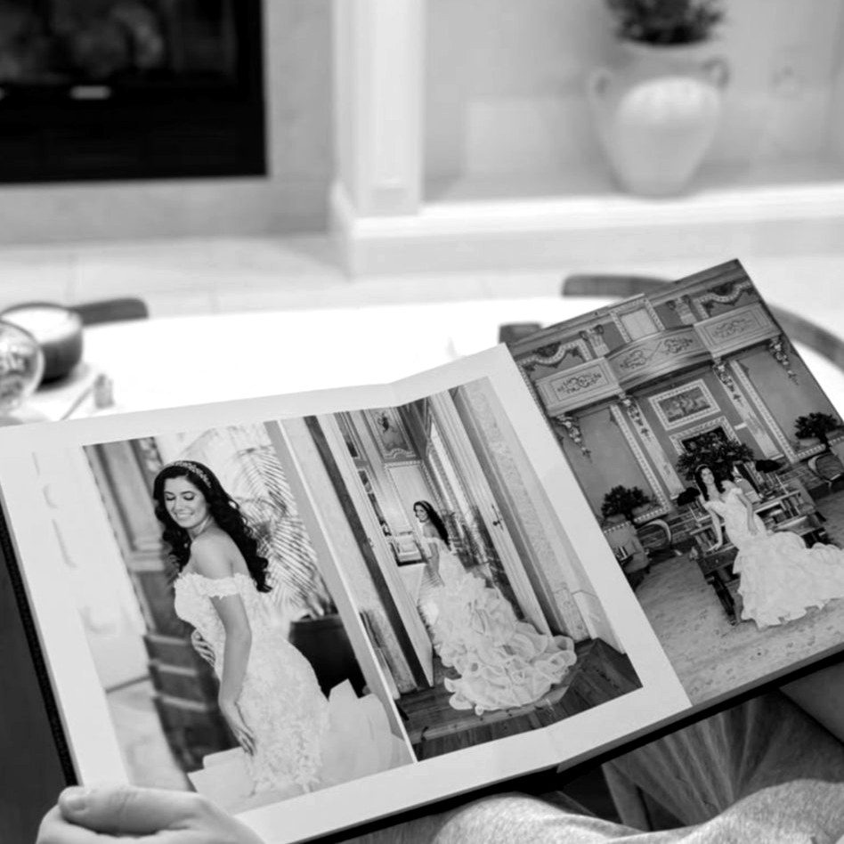 Vicky and Sam's album open on a spread of bridal portraits